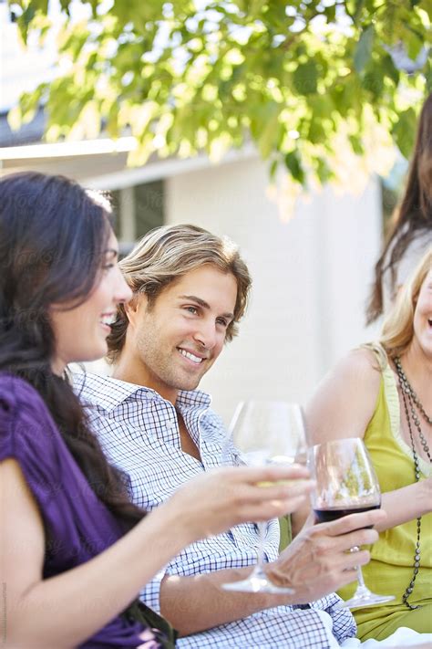 Group Of Friends Drinking Wine Together Outdoors By Stocksy