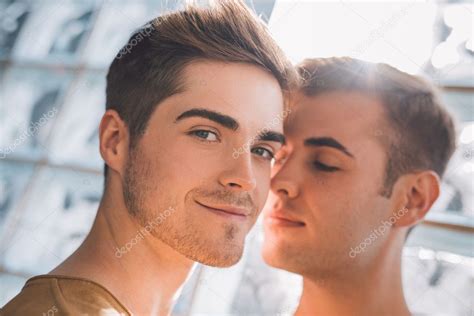 Gay Couple Standing Close Together Stock Photo By Mavoimages 127670584