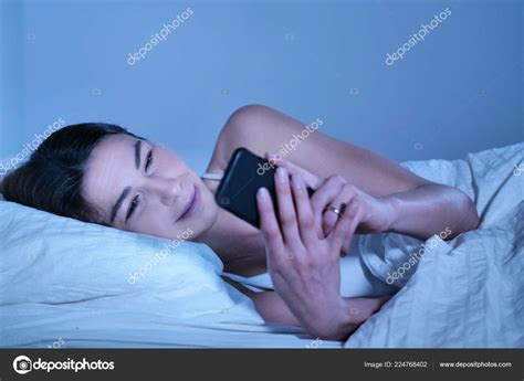 Brunette Woman Lying Bed Browsing Smartphone Stock Photo Hquality