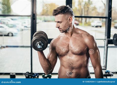 Handsome Shirtless Muscular Sportsman Training With Dumbbell Stock