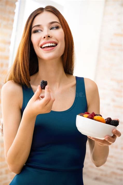 Happy Smiling Brunette Woman With Plate Of Fruits Indoors Dieting