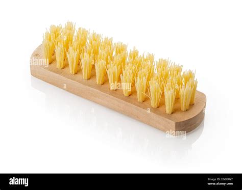 Close Up Of New Wooden Cleaning Brush With Coarse Stiff Yellow Bristles