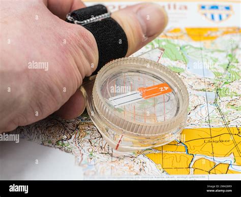 Hand Holding A Compass On An Orienteering Map Stock Photo Alamy