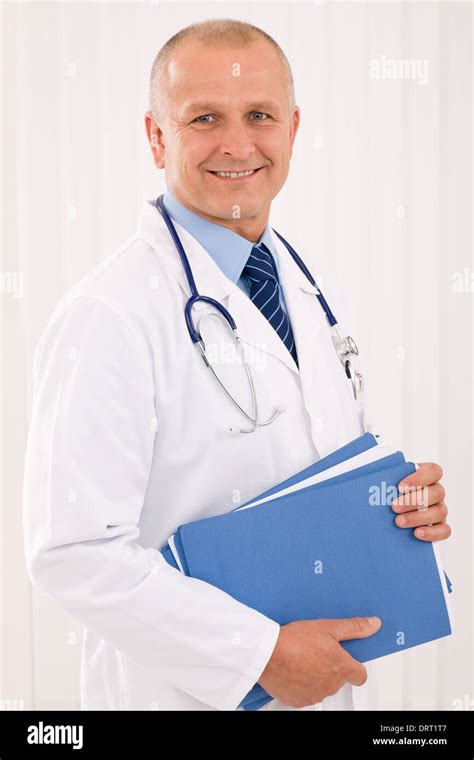 Mature Doctor Male Portrait With Folders Stock Photo Alamy