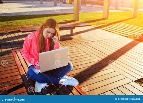 Blonde Hair Female Student Focused And Busy Using Laptop Computer At