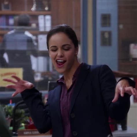 A Woman Standing In An Office With Her Hands Out