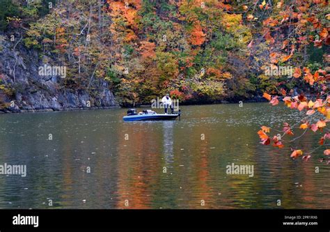 Fisherman Wets A Line On The Calm Waters Of The Holston River In