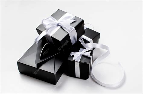 Premium Photo | Black gift box and white ribbon