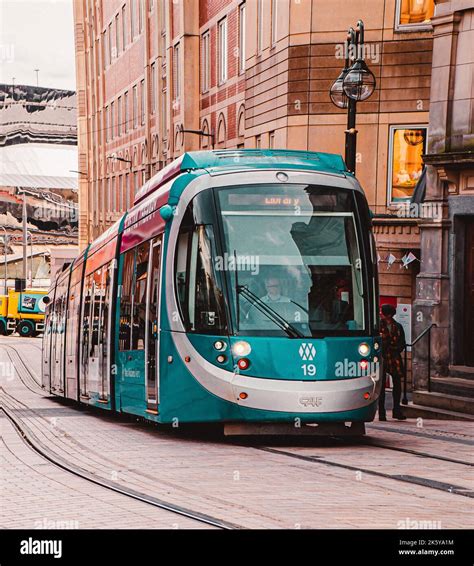 A Scenic View Of A Blue Tram Passing By In The City Of Liverpool Stock