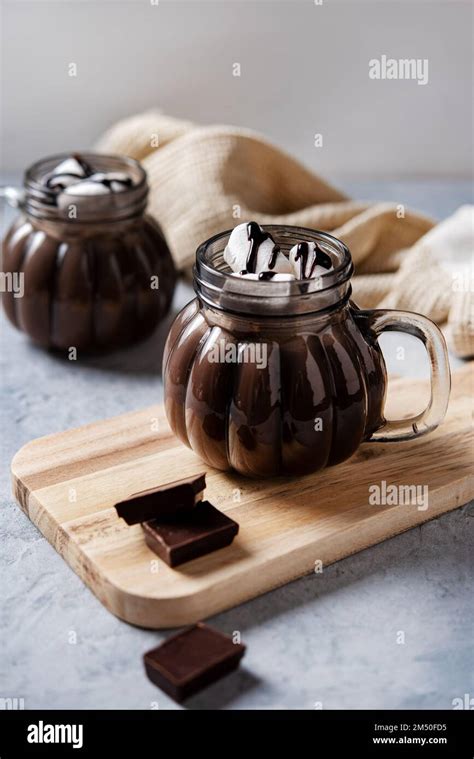 Two Cups Of Aroma Hot Chocolate With Marshmallows On A Blue Background Concept Cozy Drink