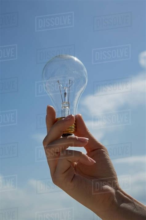 Close Up Of Hand Holding Light Bulb Stock Photo Dissolve