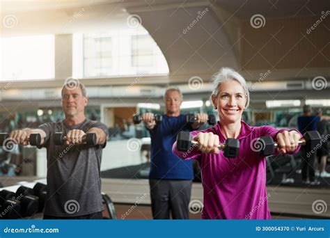 Training Fitness Or Senior People With Dumbbells At Gym For Club