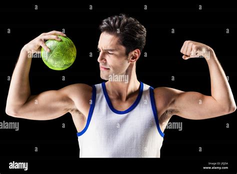 Confident Athletic Man Holding Ball And Showing Muscles Stock Photo Alamy