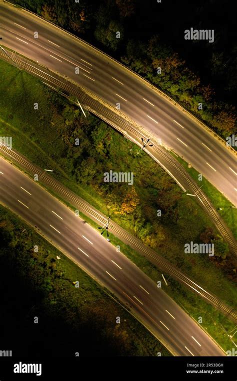 Top down view to road. Romantic night aerial photo of cars traveling. The light on the road at ...