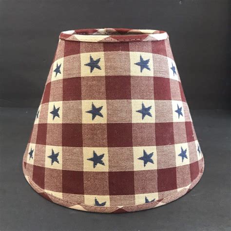 A Red And White Checkered Lamp Shade With Blue Stars On The Bottom Is Shown