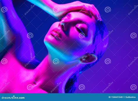 Fashion Model Woman In Colorful Bright Neon Lights Posing In Studio