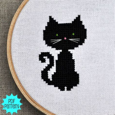 A Cross Stitch Black Cat With Green Eyes