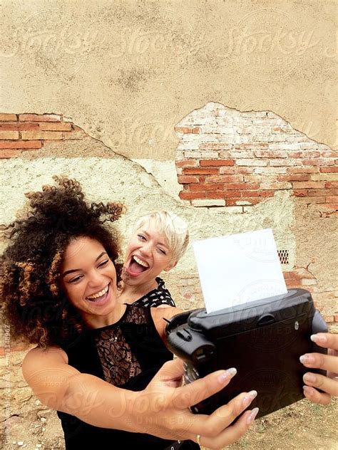 Smiling Friends Taking Selfie With Polaroid By Stocksy Contributor