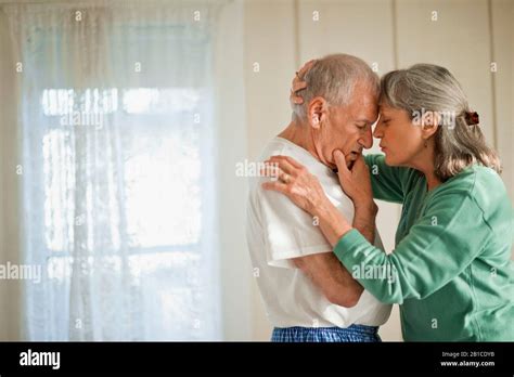 Senior Woman Comforting Her Unwell Husband Stock Photo Alamy