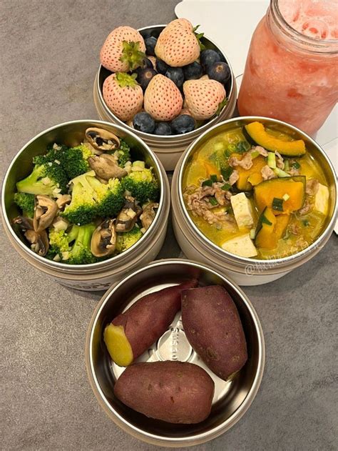 Four Metal Bowls Filled With Different Types Of Food