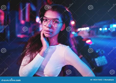 Portrait Of A Beautiful Young Woman With Glasses In Futuristic Neon