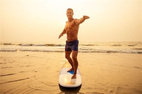 Premium Photo Surfer Fitness Male With A Muscular Body With His