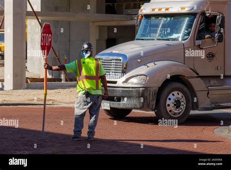 Flagger Holding Stop Sign At Construction Site Stock Photo Alamy