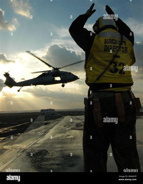 Us Navy An Aviation Boatswain S Mate Directs An Mh S Seahawk