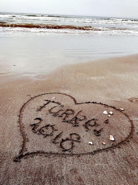 Premium Photo Close Up Of Text On Sand At Beach