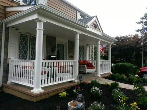 Covered Front Porch With Railings Round Columns Paver Walkway And