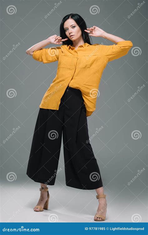 Brunette Woman Posing In Yellow Blouse Isolated On Grey Stock Image Image Of Woman Model