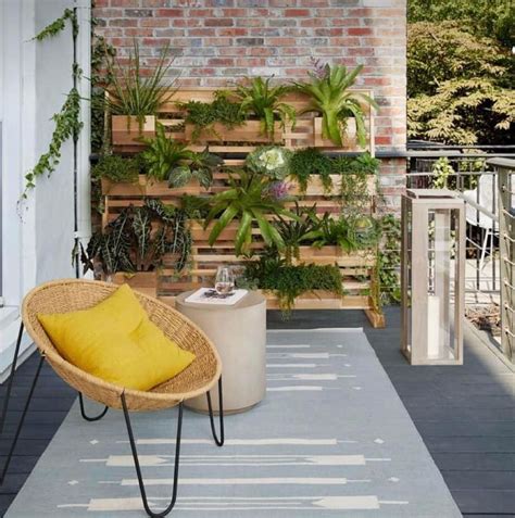 A Balcony With Potted Plants And A Yellow Pillow On The Chair Next To It