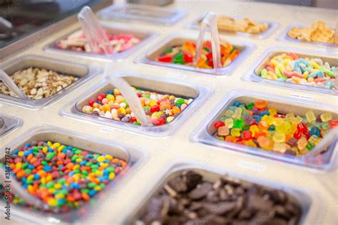 Fotka A View Of Several Containers Full Of Popular Ice Cream Toppings