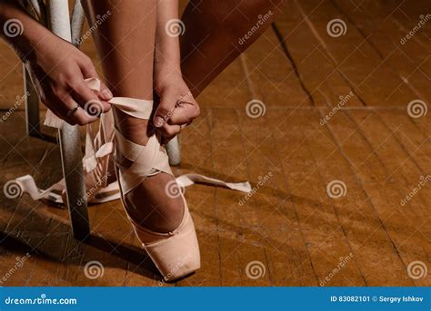 Ballerina Tying Ballet Shoes Sitting On The Stage Stock Image Image Of Hands Grace 83082101