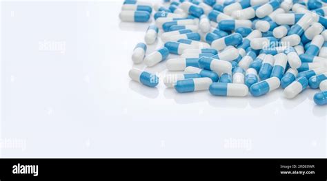 Blue White Antibiotic Capsule Pills On White Background Pile Of