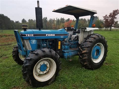 Blue Ford Tractor on Lush Green Field