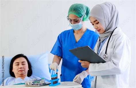 Asian Female Nurse In Face Mask Safety Goggles Blue Uniform Collect