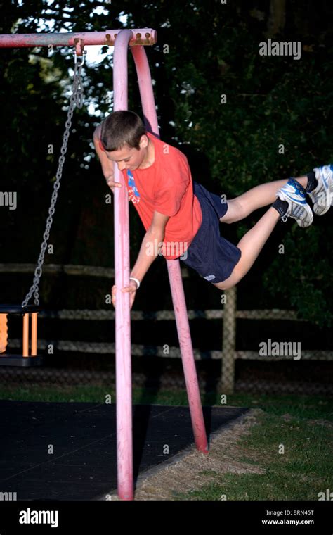 15 Year Old Boy Doing Parkour In A Childrens Playground Stock Photo