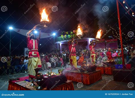 Nepalese Hindu Priests Performing Aarti Ceremony At The Lakeside