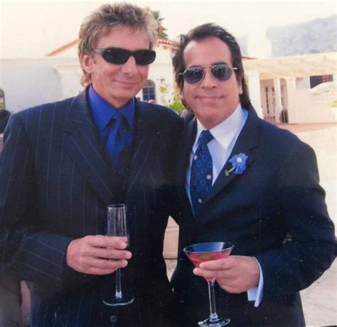 Two Men Dressed In Suits And Sunglasses Holding Wine Glasses With One