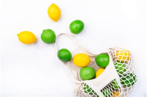 Premium Photo Organic Lemons And Limes In Reusable Ecofriendly String