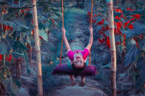 Premium Photo Full Length Of Girl Sitting In Swing In Farm