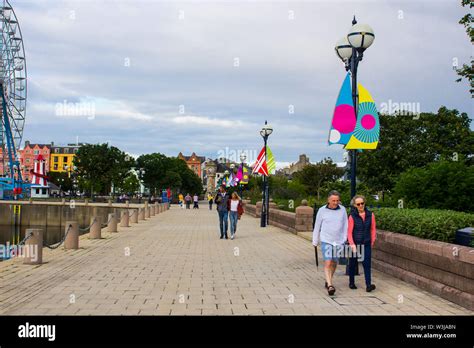 11 July 2019 Pedestrians Stroll The Promenade At The Seafront Marina In