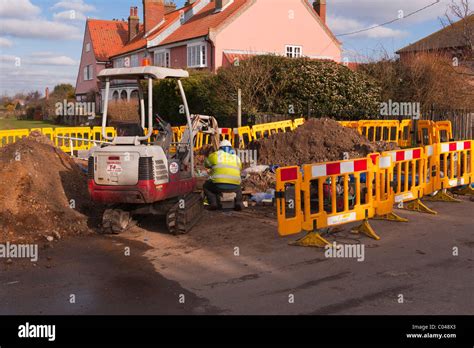 Workmen From May Gurney Digging Up The Road In Southwold Suffolk