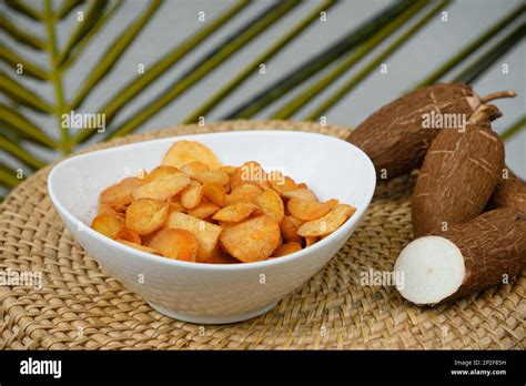 Organic Manioca Or Cassava Chips In Bowl And Tapioca Tuber Indonesia