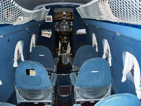 Boeing 247 Interior with Blue Seats and White Curtains