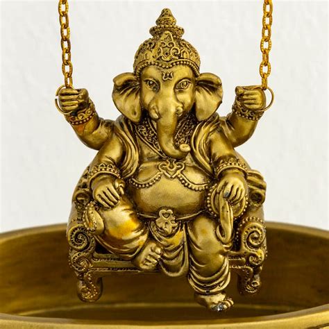 Buy Dhyana Gold Textured Polyresin Ganesha On Swing Figurine From Home