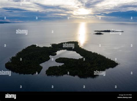 Sunrise Illuminates A Remote Island And Lagoon Off The Coast Of New