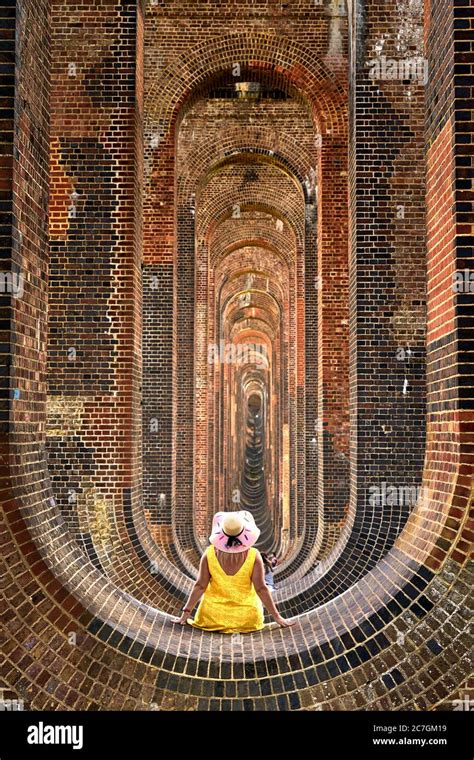 A Woman Poses For A Photograph As People Enjoy A Day Out At The Ouse