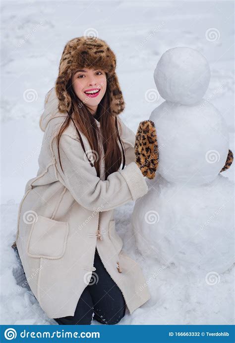 Funny Santa Girl Posing On Winter Weather Girl Playing With Snowman In